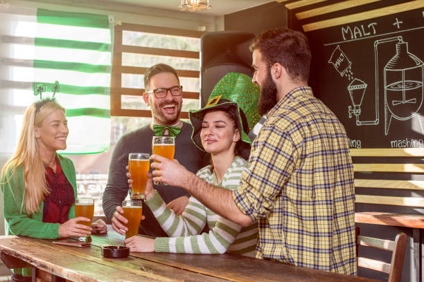 istock Four friends celebrate St Patrick day in pub 904824532