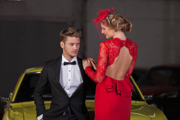 young elegance couple at the garage with her retro car - haute couture beautiful smoking beauty imagens e fotografias de stock