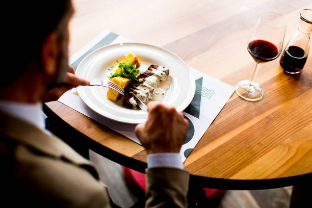istock Senior man eating lunch in restaurant 904827120