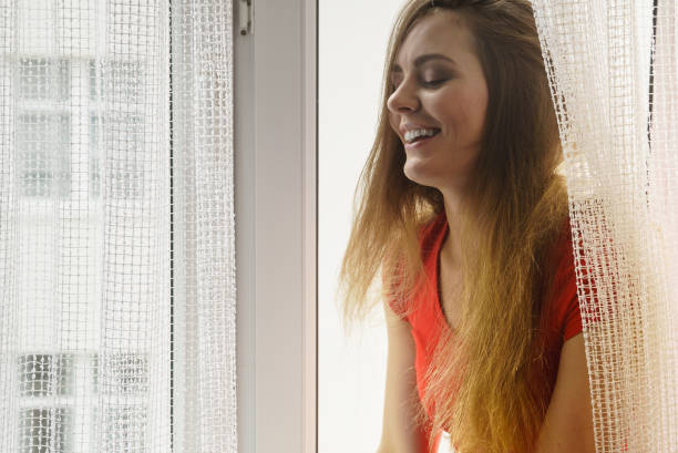 istock Happy woman sitting on windowsill, energizing morning 904829866