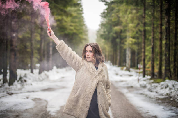 istock Young woman portrait outdoors with pink smoke bomb 904832468