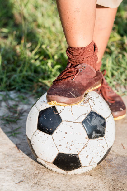 istock Brown sneakers on a soccer ball. 904832644