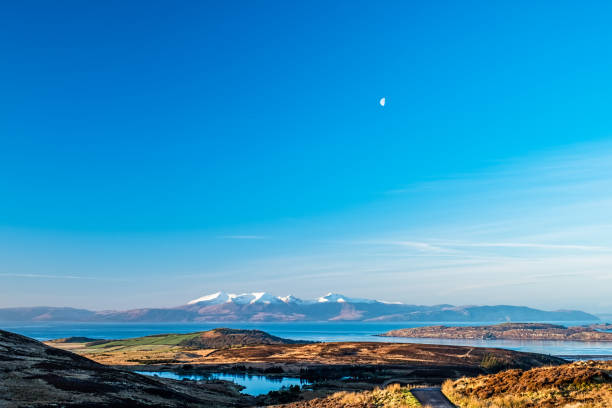 The Arran Hills early mornoing in winter snow capped and a small moon above in the sky