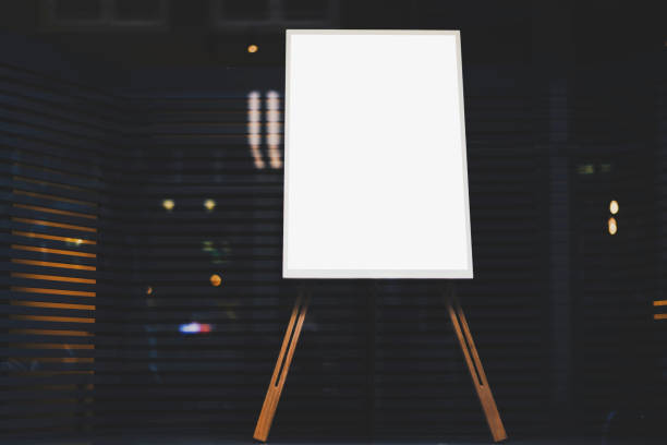 istock White stylish chalkboard with mock up copy space are for your text message or advertising promotional content, empty presentation wooden board standing on the glass storefront 904833130