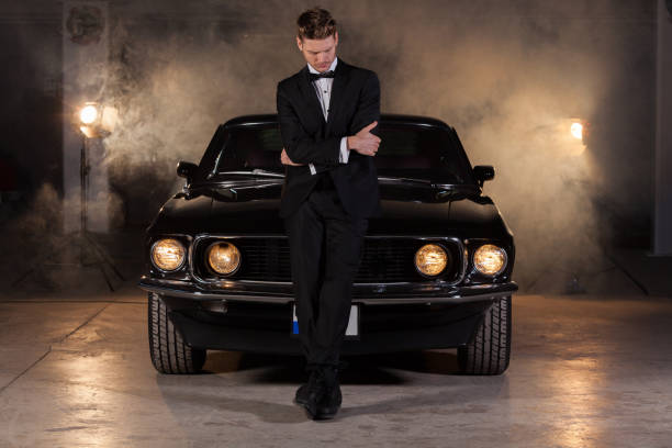 istock Young handsome man with classic car at auto repair shop 904833676