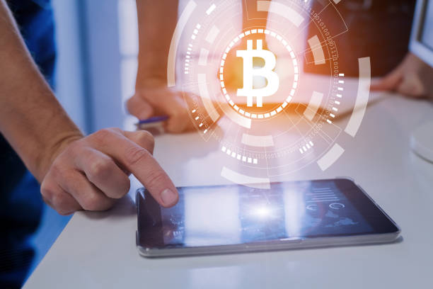 istock People trading, investing, paying with bitcoin cryptocurrency, BTC symbol, tablet 904833830