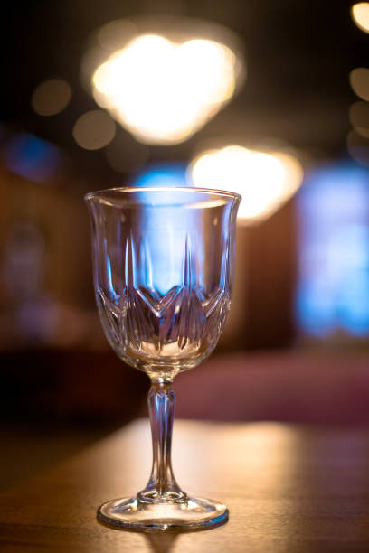 istock Empty glass on table in night club or restaurant, closeup 904836438