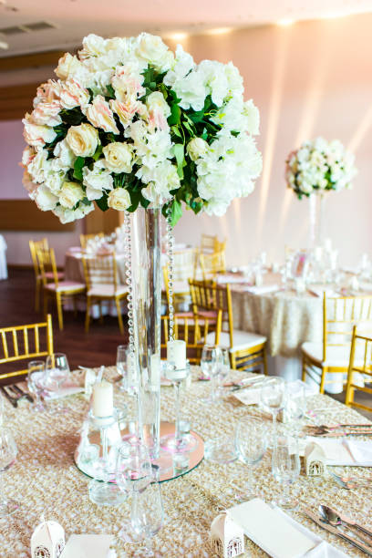 istock Large vase with beautiful roses stands on rich decorated wedding table 904836896