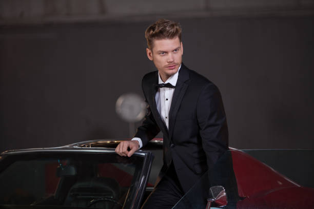 istock Young handsome man drive classic car 904837600