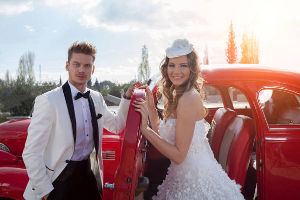istock Young elegance newlywed couple at the retro car 904840672