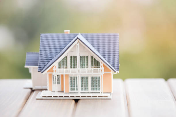 istock Miniature model house on wood. 904841228