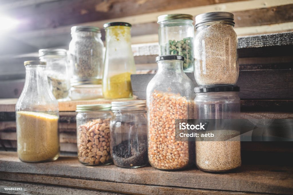 Glass Jars of Spices, Grains and Dry Food Few Seeds, Grain and Cereals in Glass Jars with Wooden Background Garbage Stock Photo
