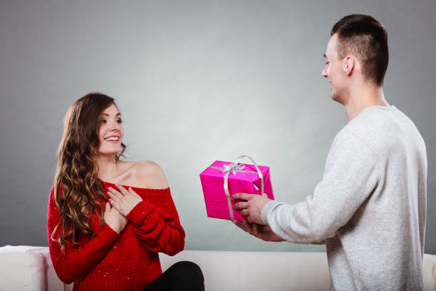 istock happy romantic couple with gift 904842424