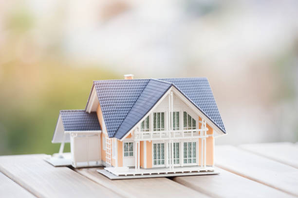 istock Miniature model house on wood. 904845018