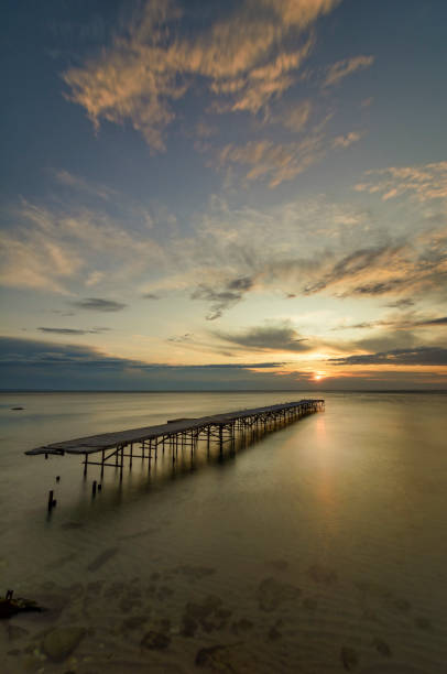 istock Seascape with a Concrete broken bridge at sunrise 904847738
