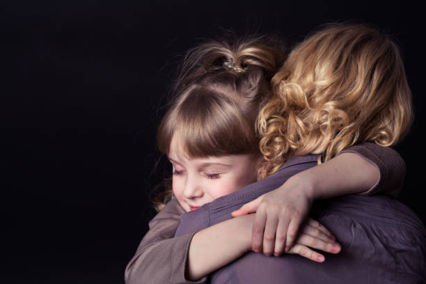 istock Girl hugging mother. 904848374