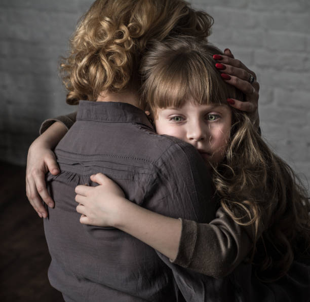 istock Girl hugging mother. 904848404