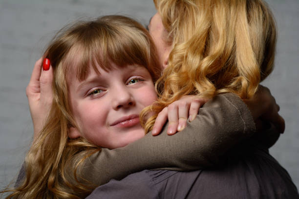 istock Girl hugging mother. 904848420