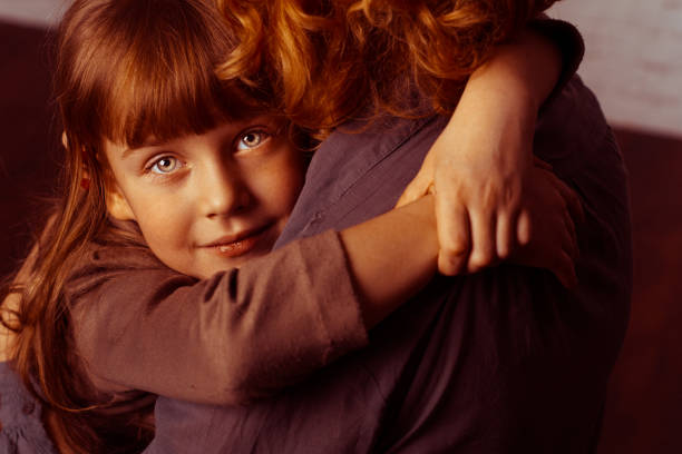 istock Girl hugging mother. 904848440