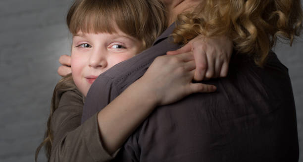 istock Girl hugging mother. 904848452