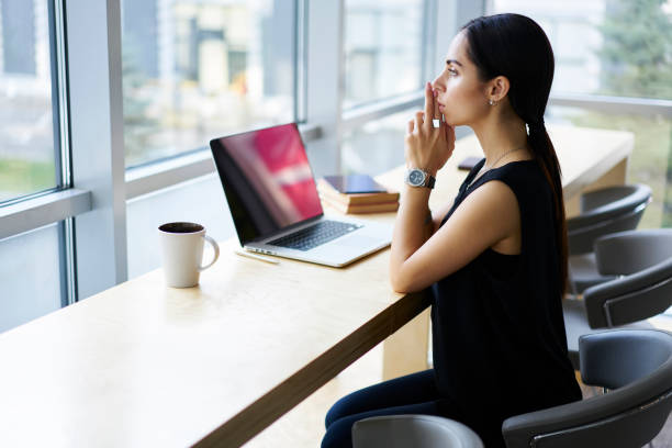 istock Serious creative manager of corporation thinking about development of new startup doing remote work in cafe interior, female entrepreneur concentrated on solving problems with business using device 904848504