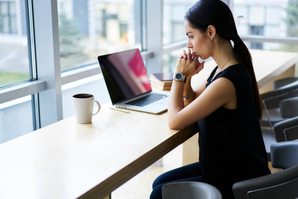 istock Serious prosperous female administrative manager thinking about productivity of new project developing strategy sitting in cafe interior, concentrated businesswoman pondering in creative ideas 904848596
