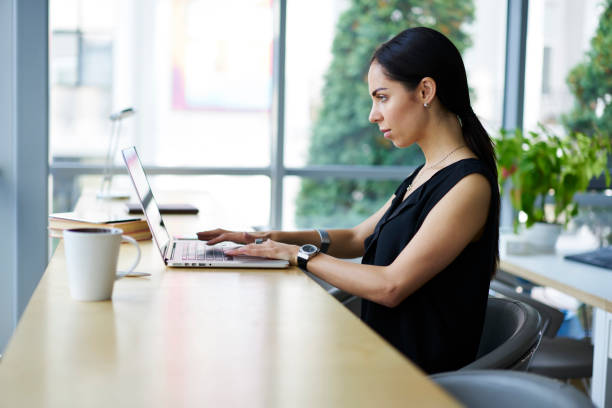 istock Confident female entrepreneur making distant work sitting in cafe interior earning money online supervising website, prosperous formally dressed manager typing on laptop computer connected to wifi 904848630