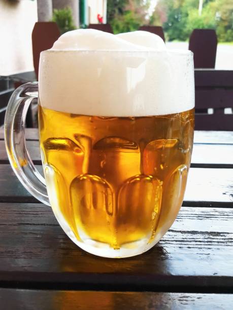 Beer in glass mug on wooden table
