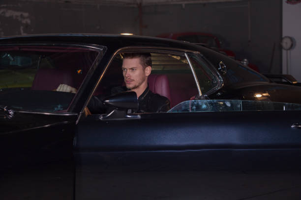 istock Young handsome man drive classic car 904856918