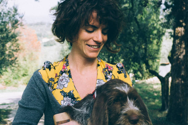 istock Young woman playing with her little dog 904860038