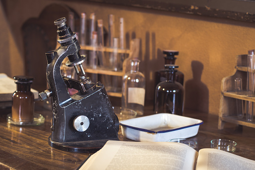 Antique laboratory  microscope and  glassware with selective focus. Science and medical research concept