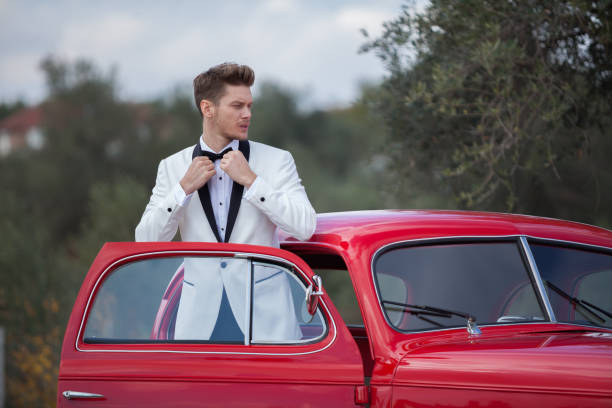 istock Young handsome man with her classic car 904861124