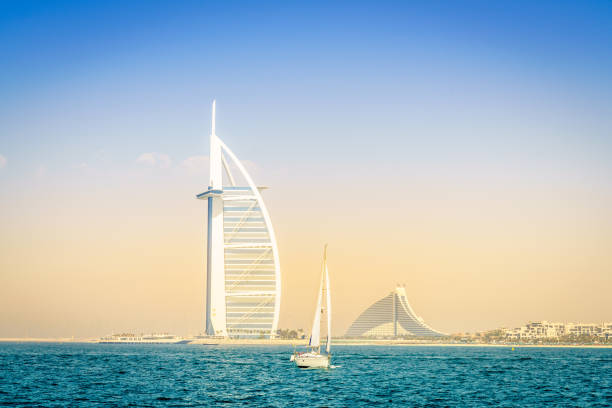 The Burj Al Arab in the background of a sail boat.