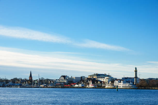istock Buildings, lighthouse and blue sky in Warnemuende 904864996