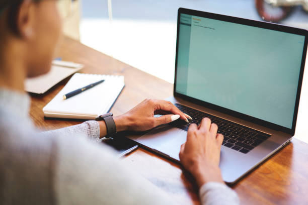 istock Back view of afro american freelancer earning money online using high speed connection to internet in coffee shop, cropped image of professional copywriter browsing web page earning money online 904867616