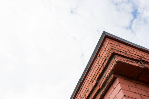 The corner of a brick building against the sky