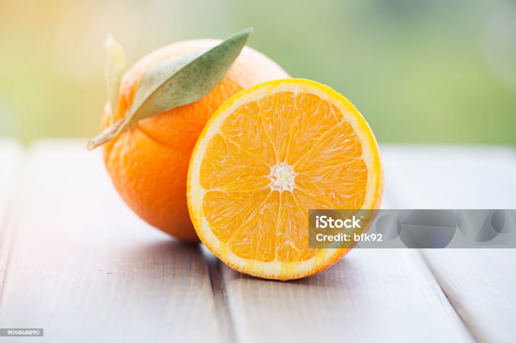 Oranges on wood background Orange isolated on wood background Orange - Fruit Stock Photo