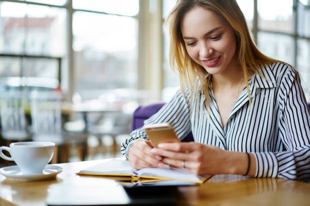istock Positive blonde female administrative manager resting on coffee break dialing number of business partner to arrange meeting in cafe, smiling young student chatting in social networks via smartphone 904880026