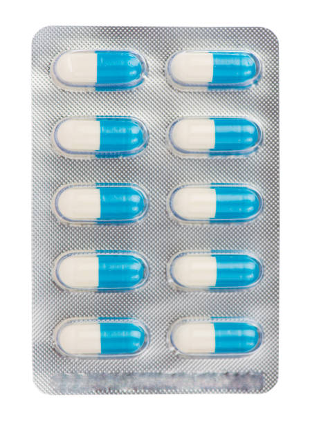 istock Blue and white capsule in transparent blister pack on white 904881120