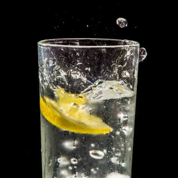 istock water splash with lemon and ice on black 904884488