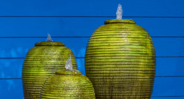 Green fountain jar and blue walls peaceful