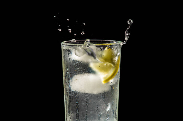 istock water splash with lemon and ice on black 904887586
