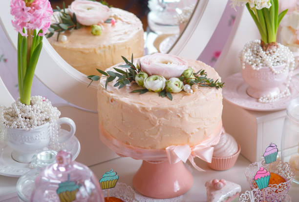istock Dessert Table at Wedding Reception. Beautiful wedding cake with flowers on table 904890324