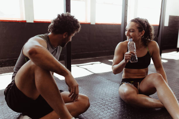 istock Couple taking a break after workout at gym 904890754