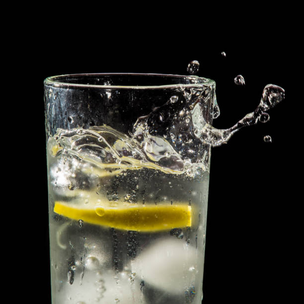 istock water splash with lemon and ice on black 904890930