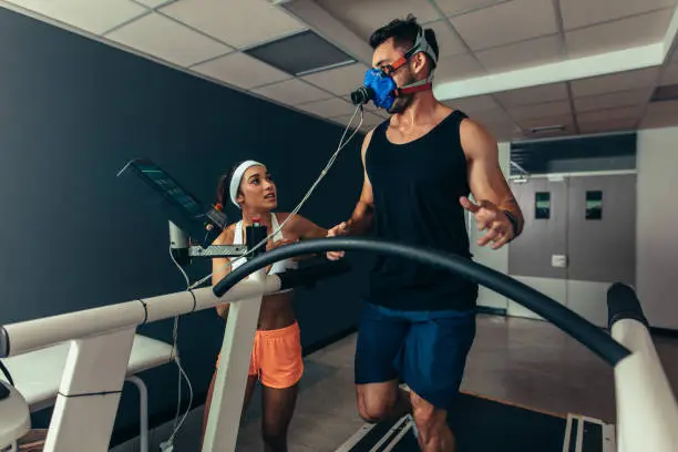 Photo of Athlete running on treadmill with female trainer