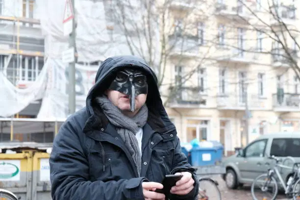 Man wearing plague black mask