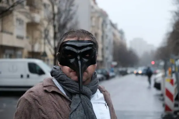 Man wearing plague black mask