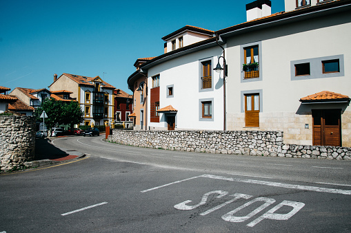 Empty road with stop symbol painted on asphalt, Colombres, Spain