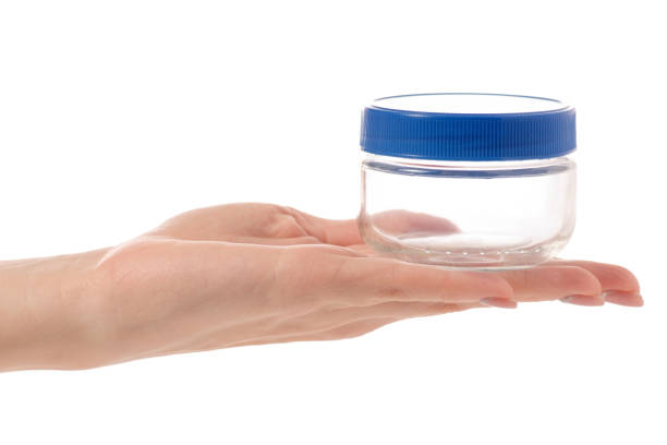 istock Glass empty jar with a lid in hand 904903312